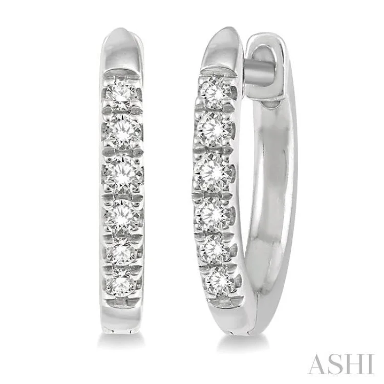 1/8 ctw Round Cut Diamond Huggie Earrings in 14K White Gold